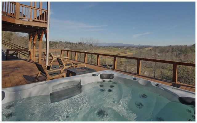 A hot tub on a balcony with a view of the surroundings
