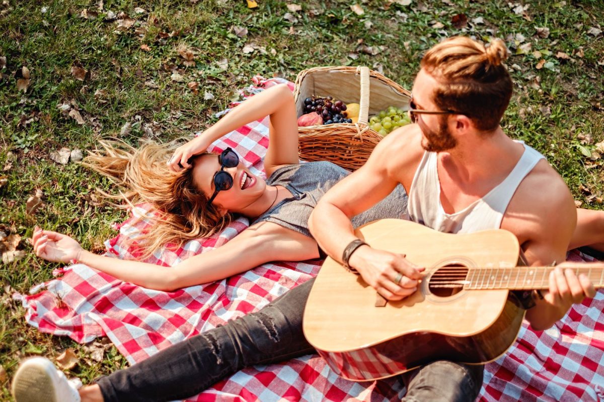 couple in grass at music festival